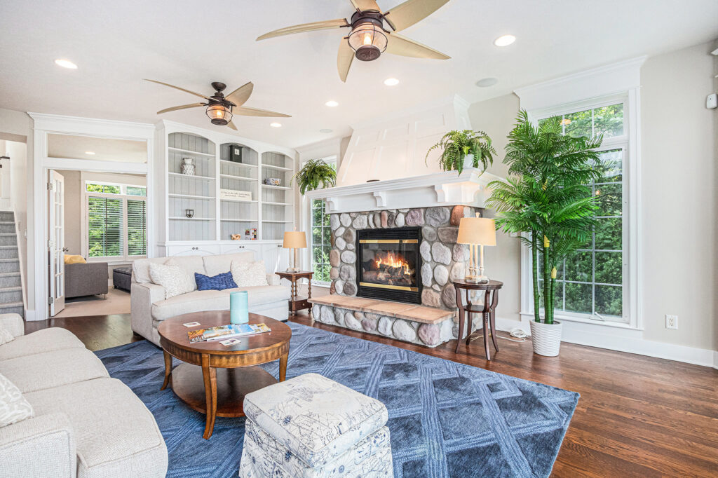 Bright living room with fireplace and blue rug