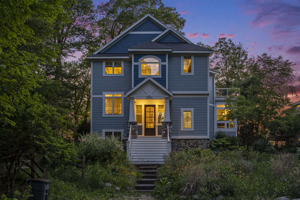 Blue two-story house at sunset