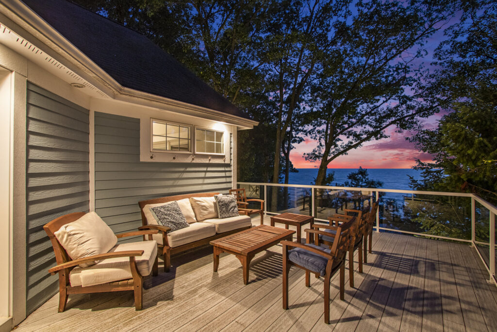 Lakeside patio with sunset view and outdoor furniture