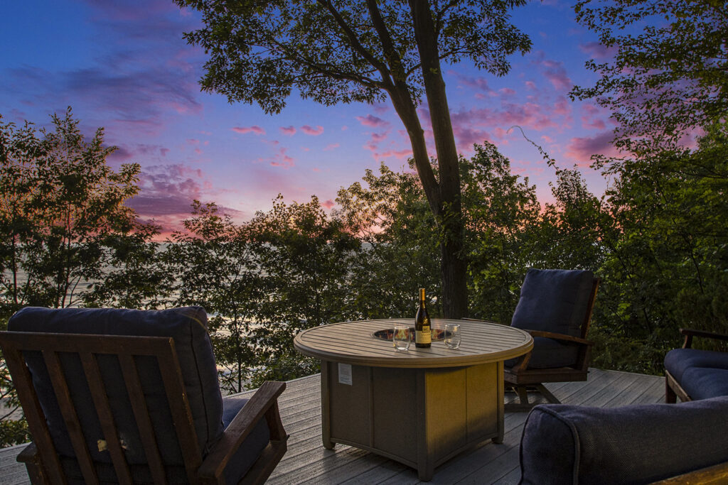 Outdoor patio with sunset and wine bottle