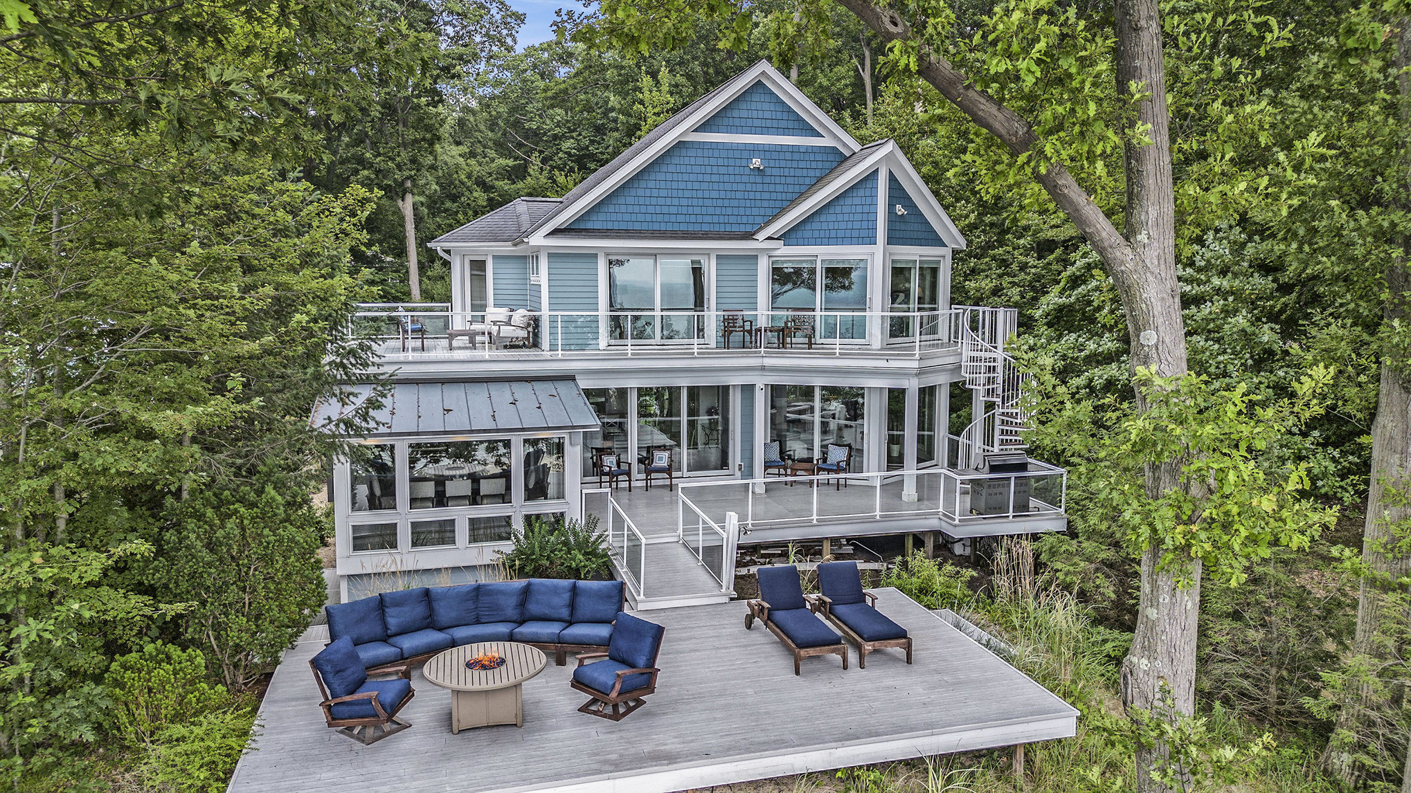 Modern blue lake house with large deck