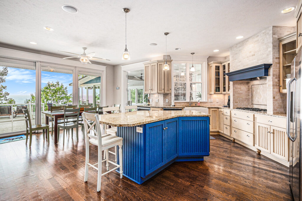 Bright kitchen with blue island and lake view