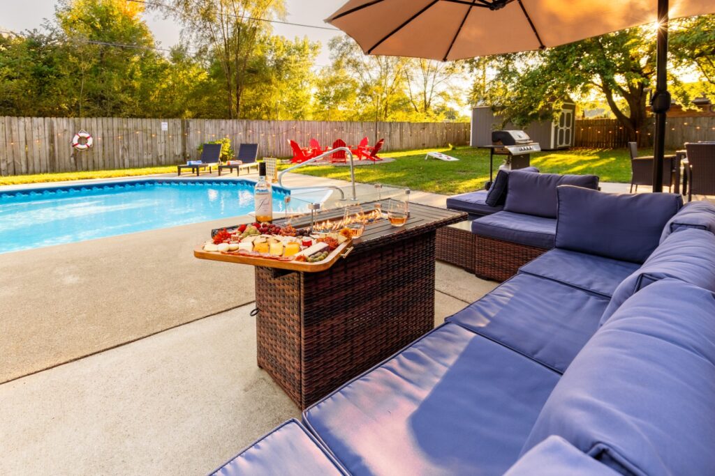 Backyard poolside patio with food and seating