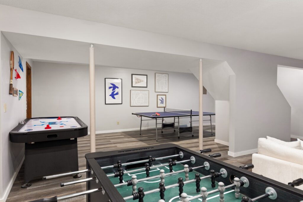 Basement game room with foosball and ping pong tables