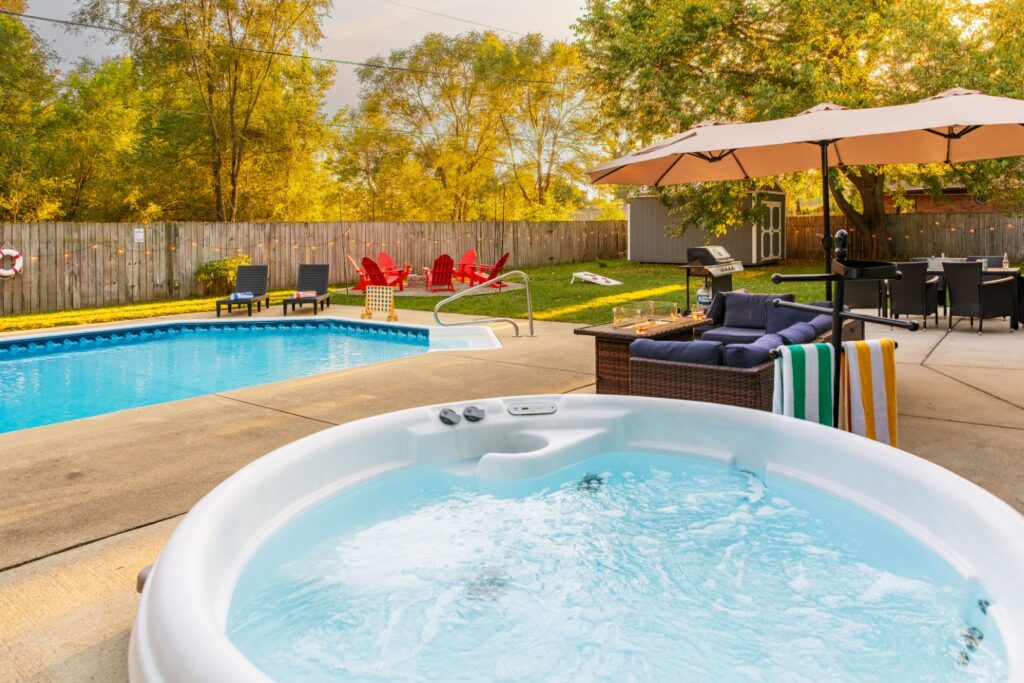 Backyard with pool, hot tub, and patio seating