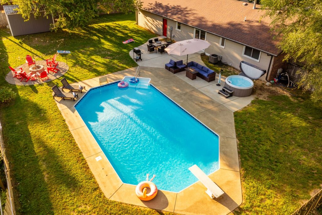 Backyard with pool, hot tub, and patio seating