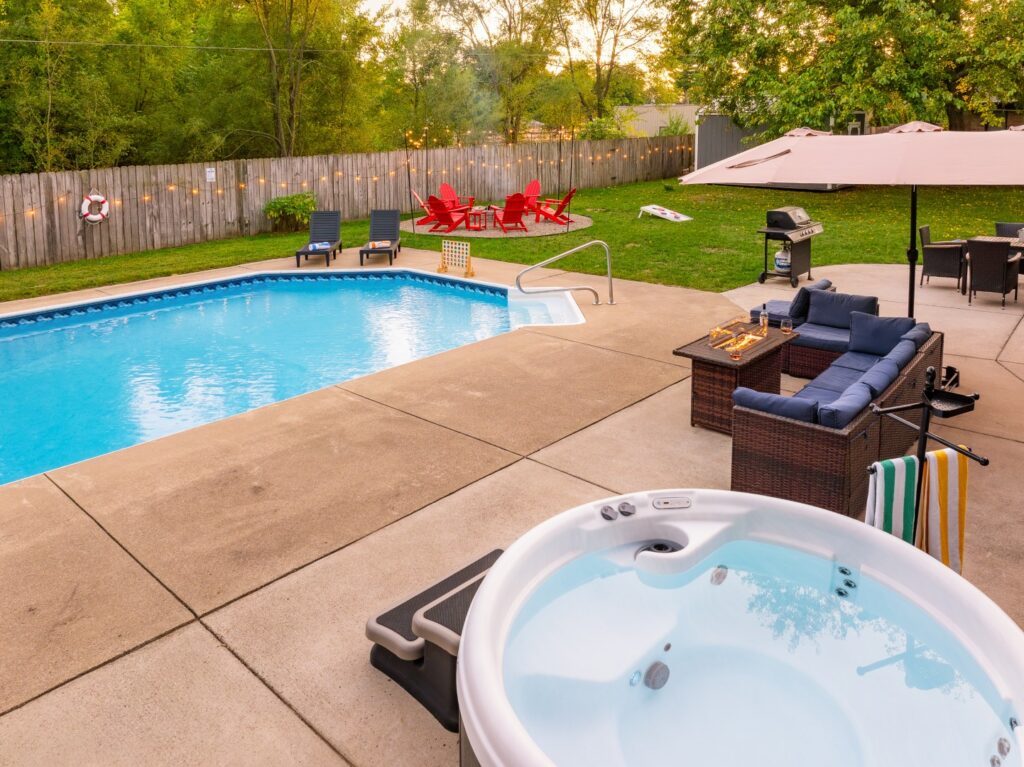 Backyard with pool, hot tub, and patio seating