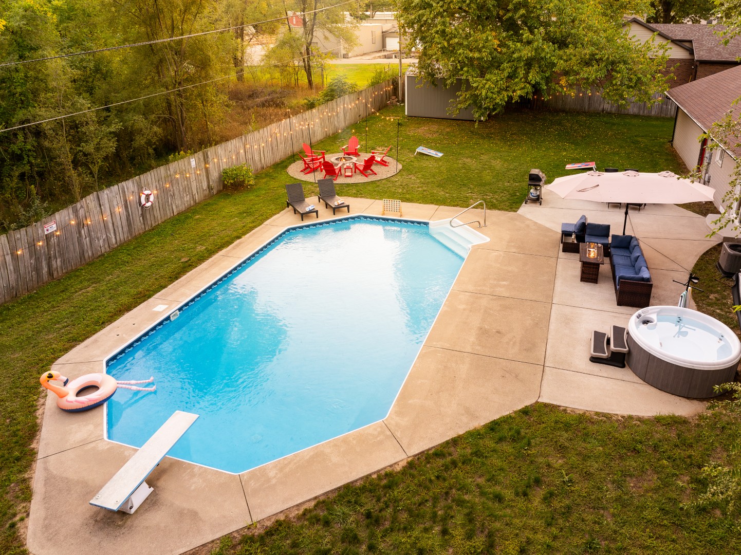 Backyard pool with patio and hot tub