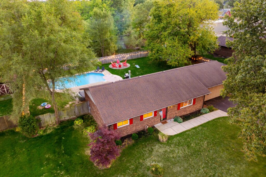 Brick house with backyard pool and patio