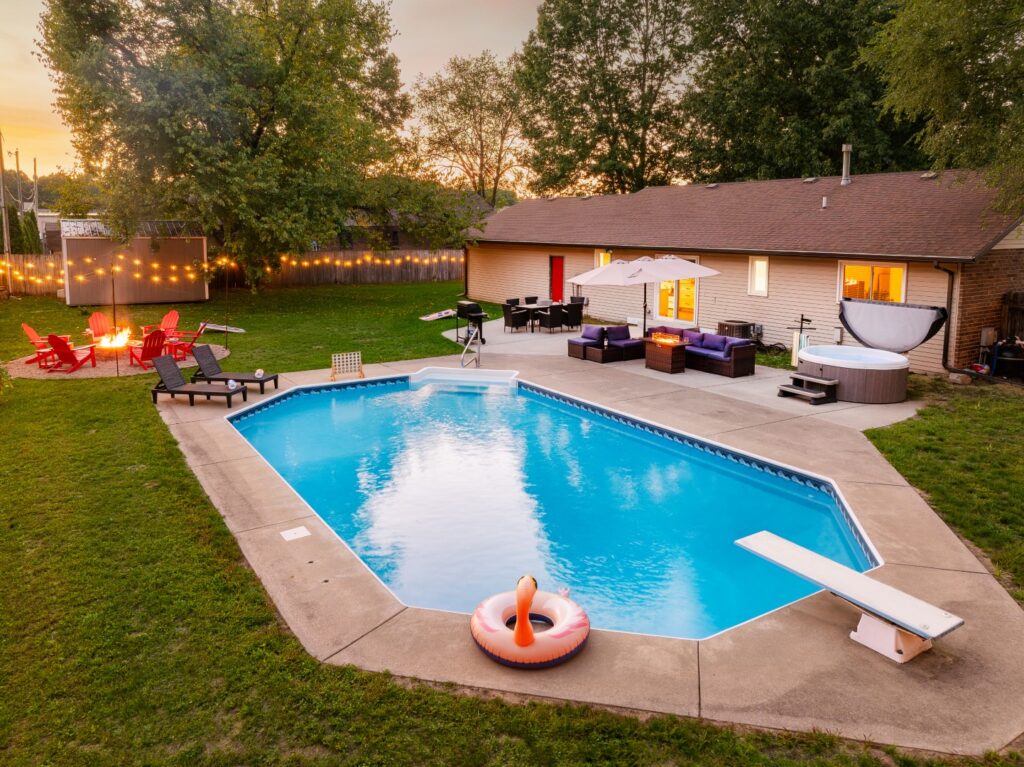 Backyard pool with patio and fire pit