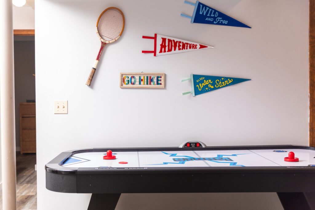 Air hockey table with adventure-themed wall decor