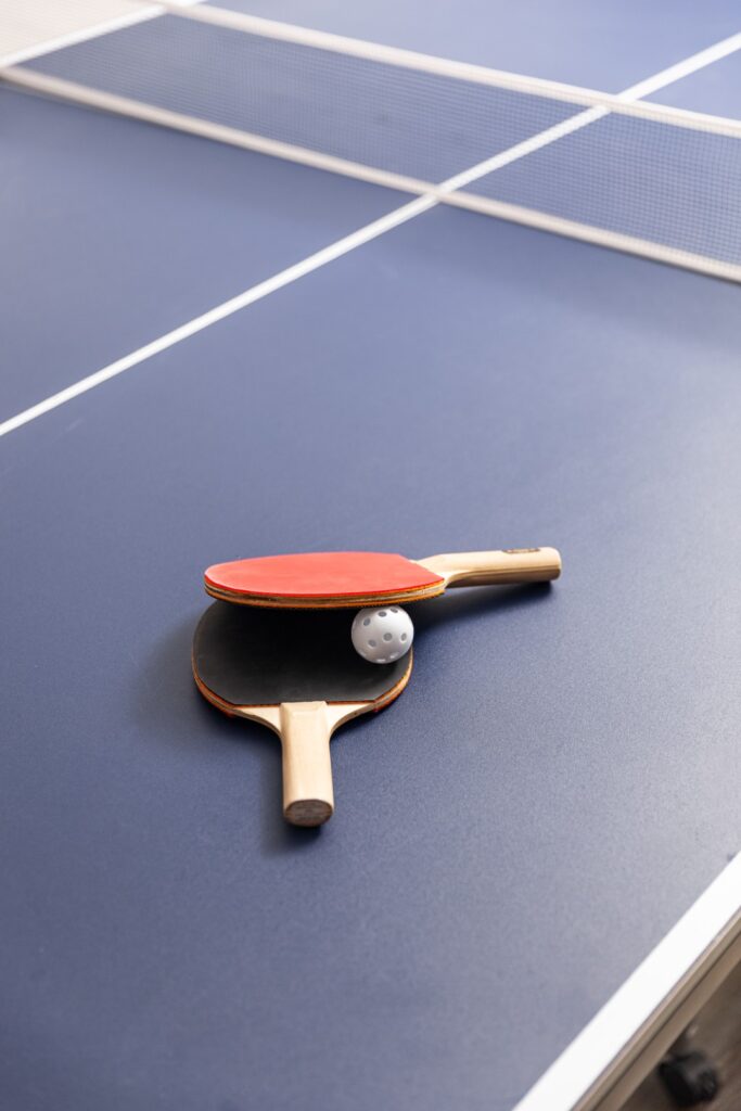 Ping pong paddles and ball on table