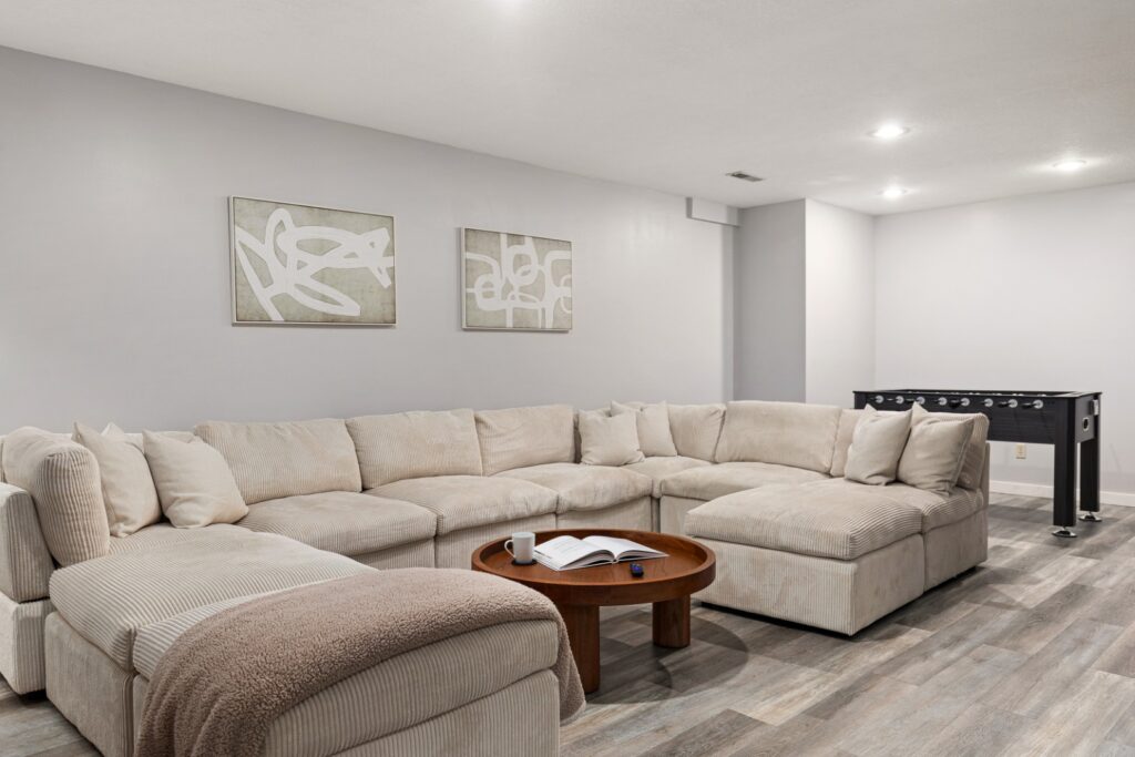 Modern living room with sectional sofa and foosball table