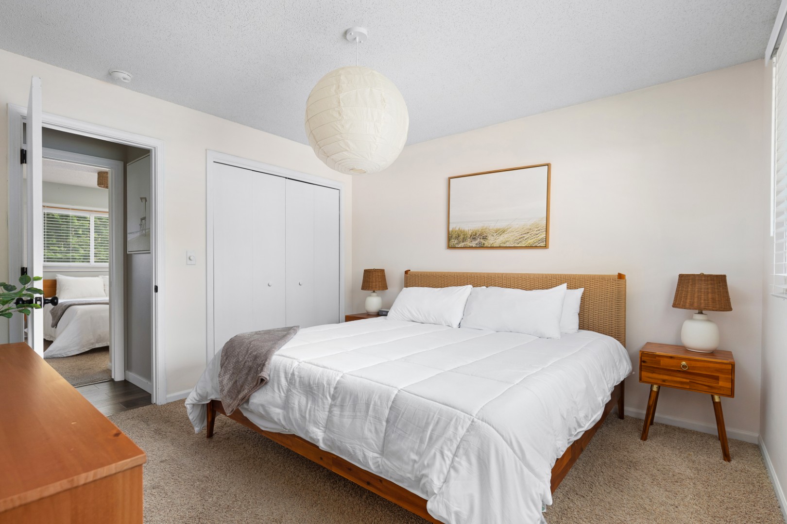 Modern cozy bedroom with white bedding and decor