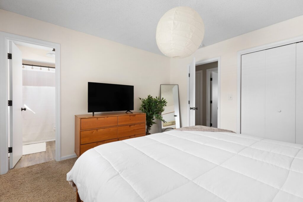Modern bedroom with TV and wooden dresser