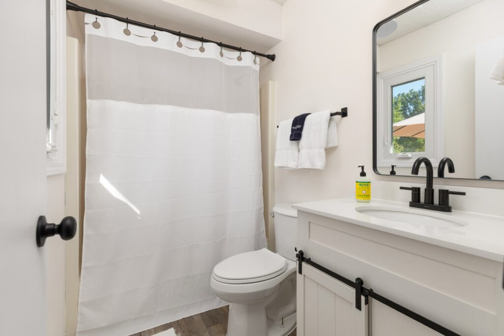 Modern bathroom with white decor and black fixtures