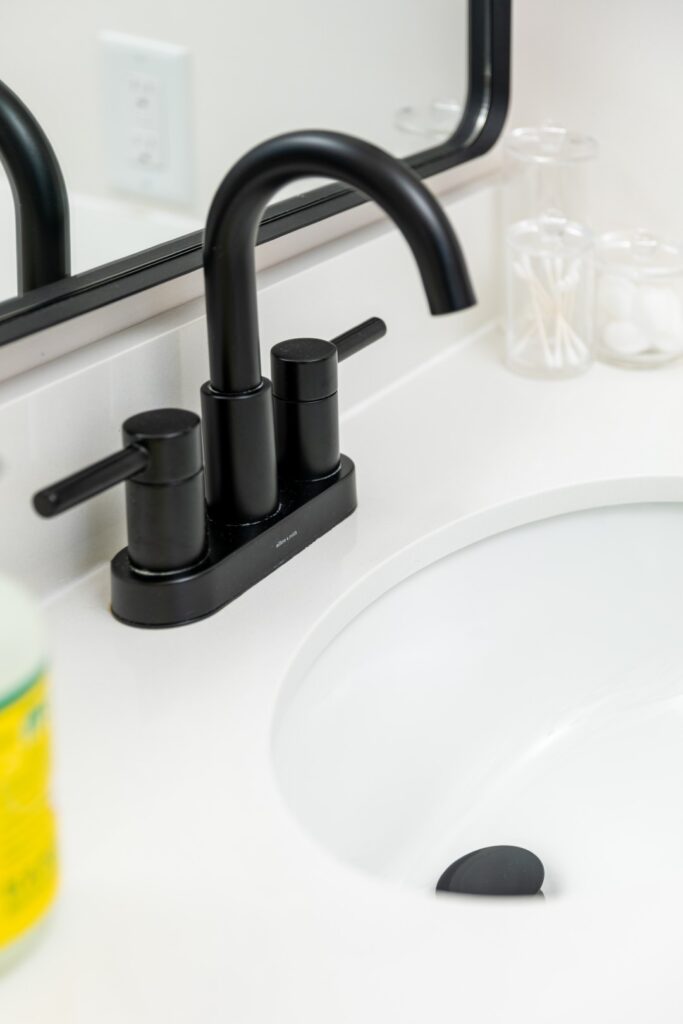 Modern black bathroom faucet on white sink