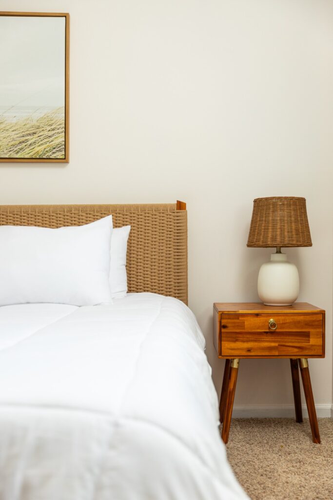 Cozy bedroom with wicker headboard and nightstand lamp