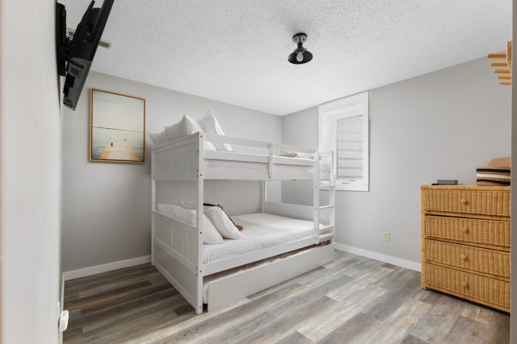 Modern bedroom with white bunk bed and dresser