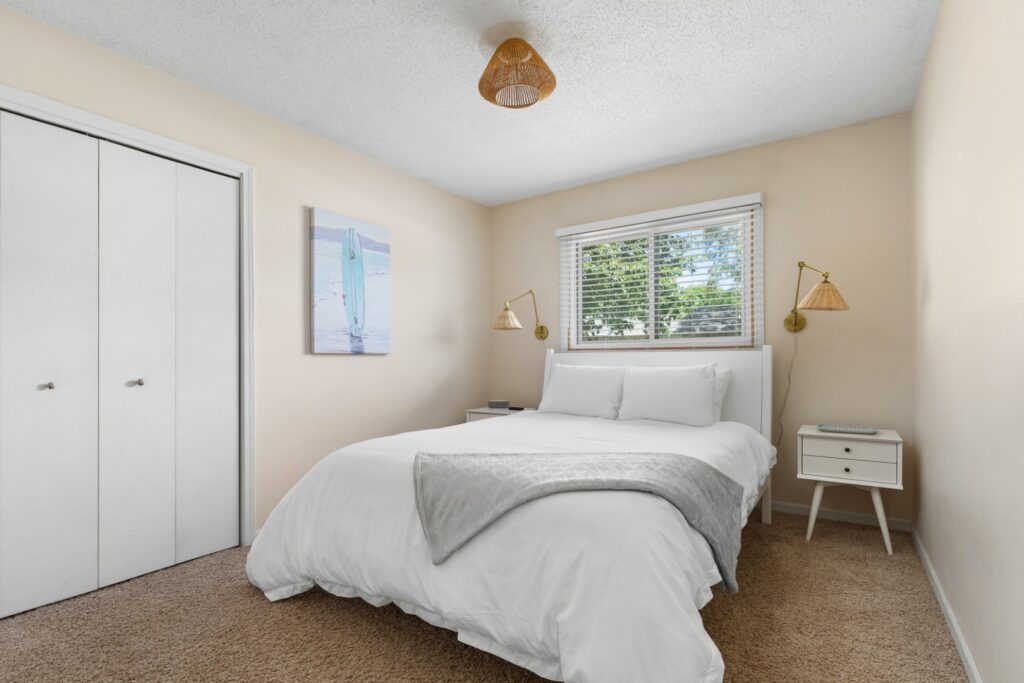 Cozy bedroom with white bedding and window view