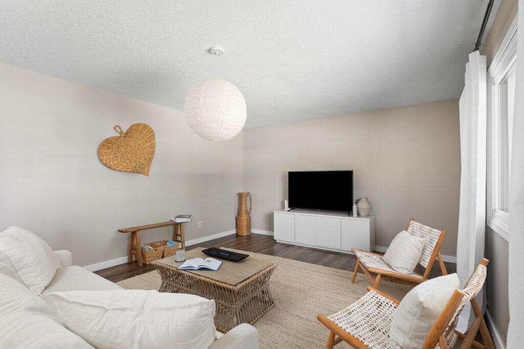 Modern living room with neutral decor and TV