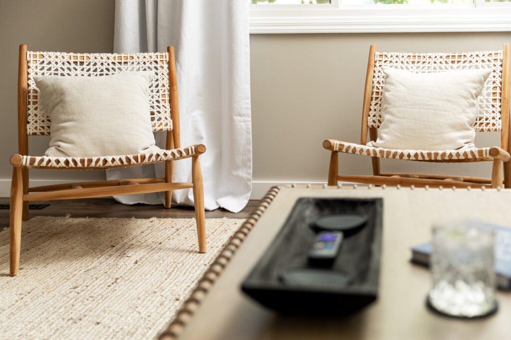 Modern living room with woven chairs and pillows