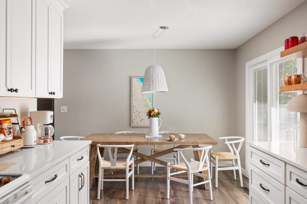 Modern white kitchen with wooden dining table