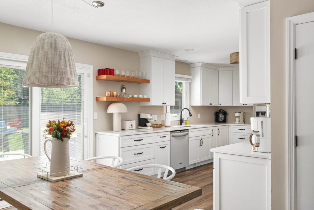 Modern white kitchen with wooden accents and sunlight