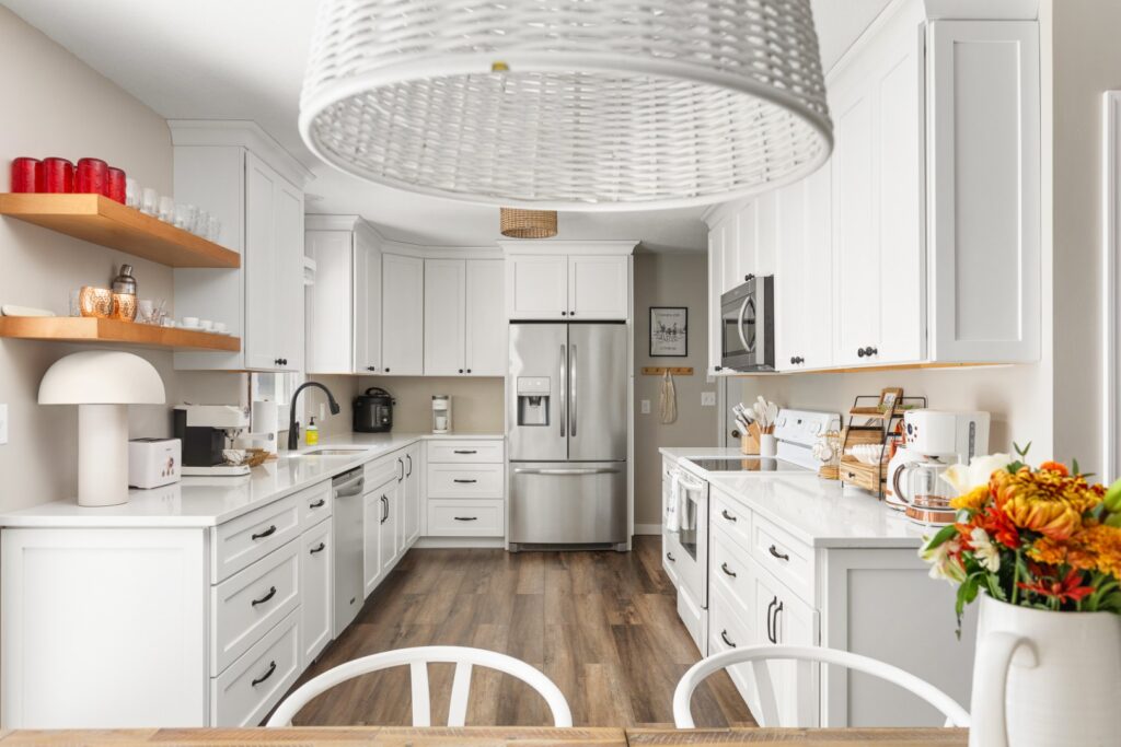 Modern white kitchen with stainless steel appliances
