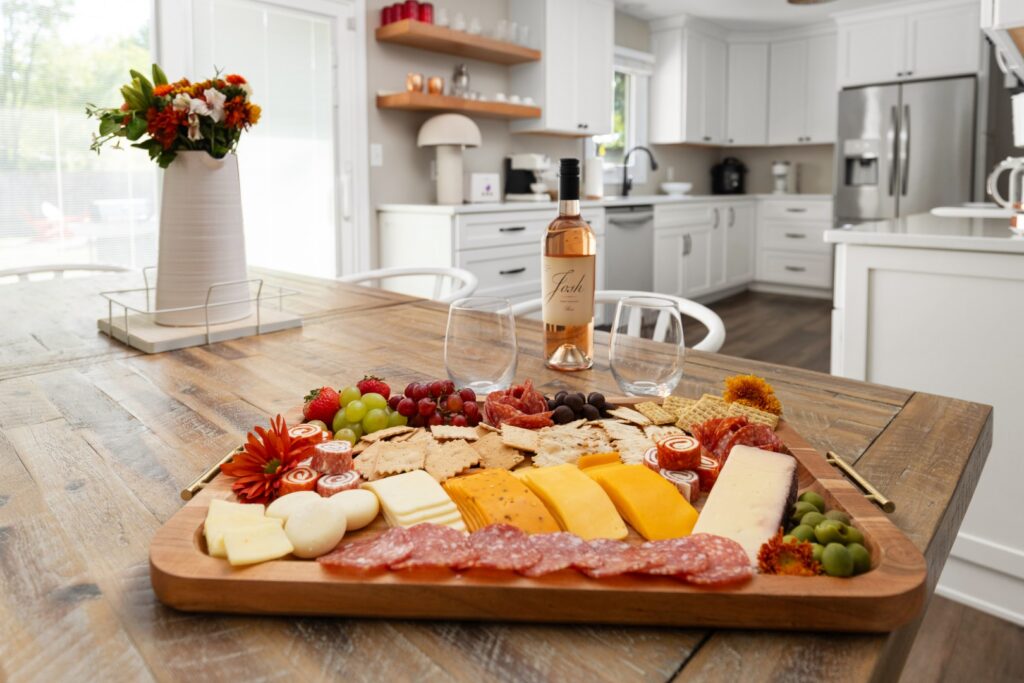 Charcuterie board with wine in modern kitchen