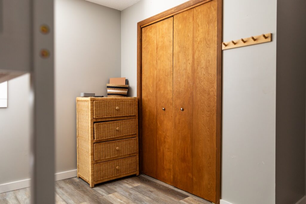 Bedroom corner with wicker dresser and closet
