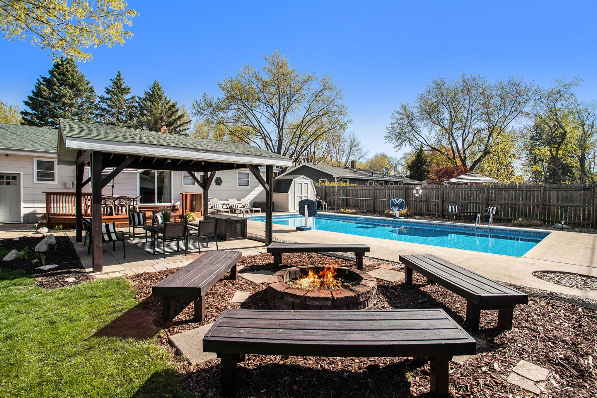 Backyard with pool, fire pit, and patio seating
