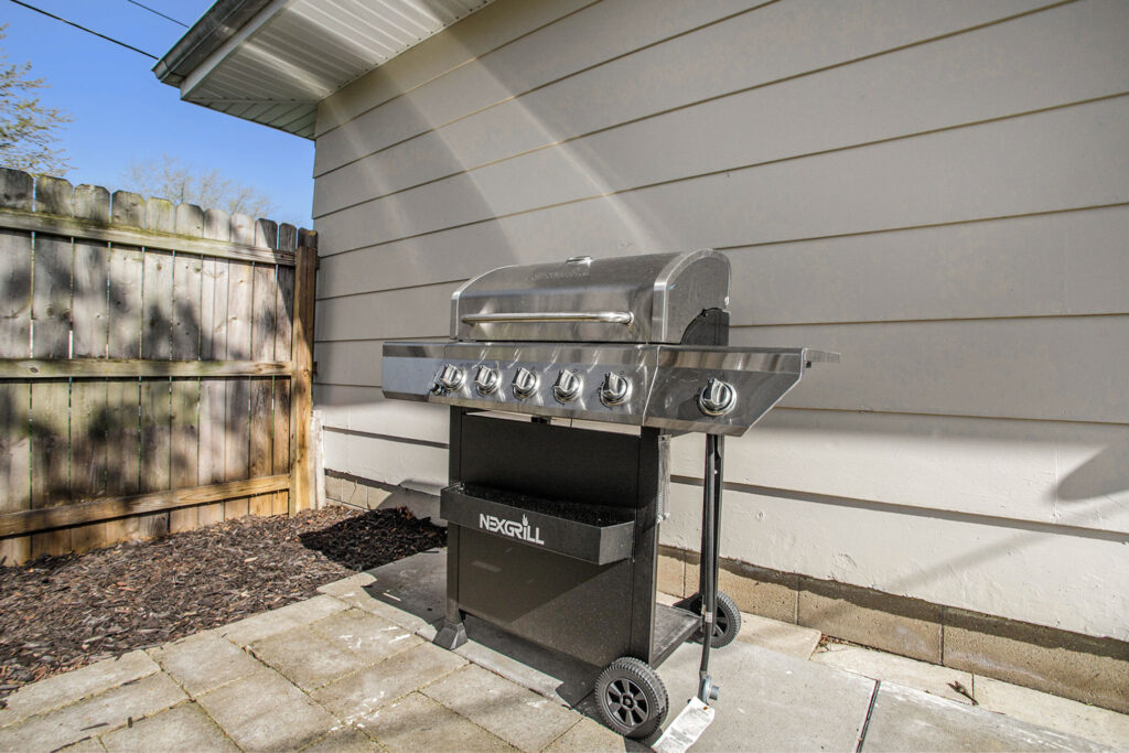 Stainless steel outdoor gas grill on patio