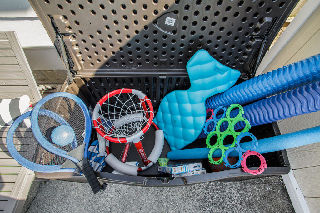 Outdoor storage box with assorted pool toys