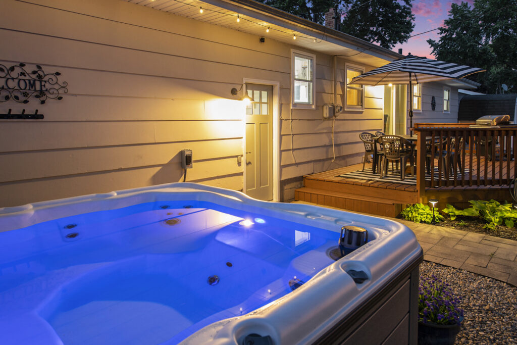 Backyard deck with hot tub at sunset