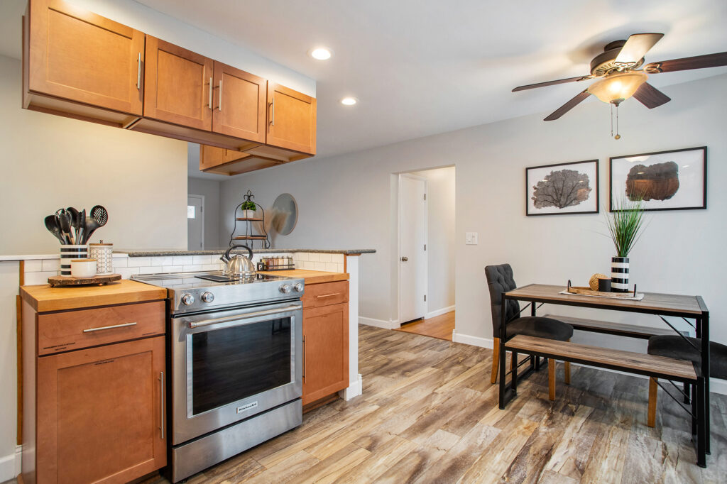 Modern kitchen and dining area with wooden cabinets