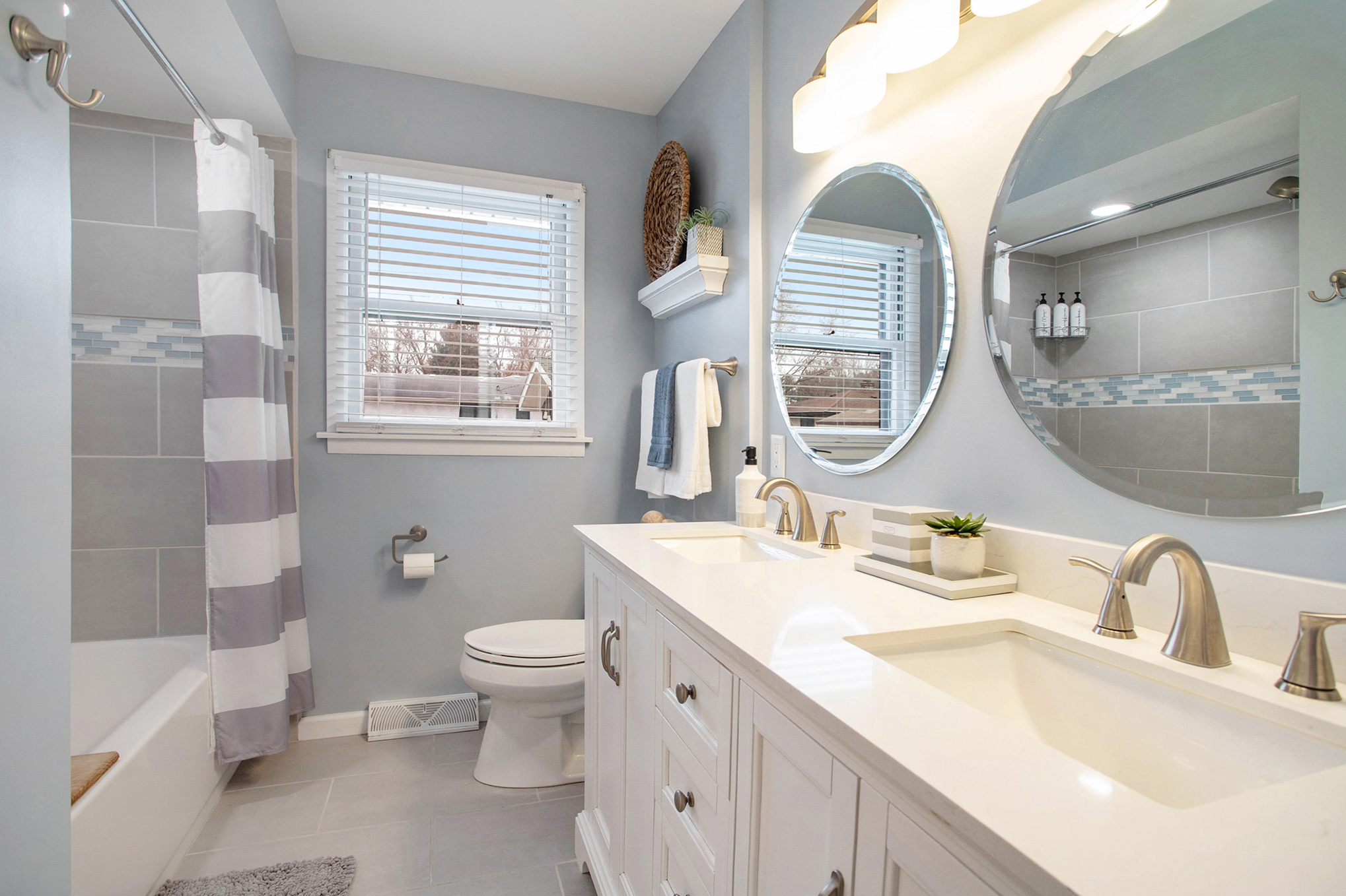 Modern bathroom with double sinks and bathtub