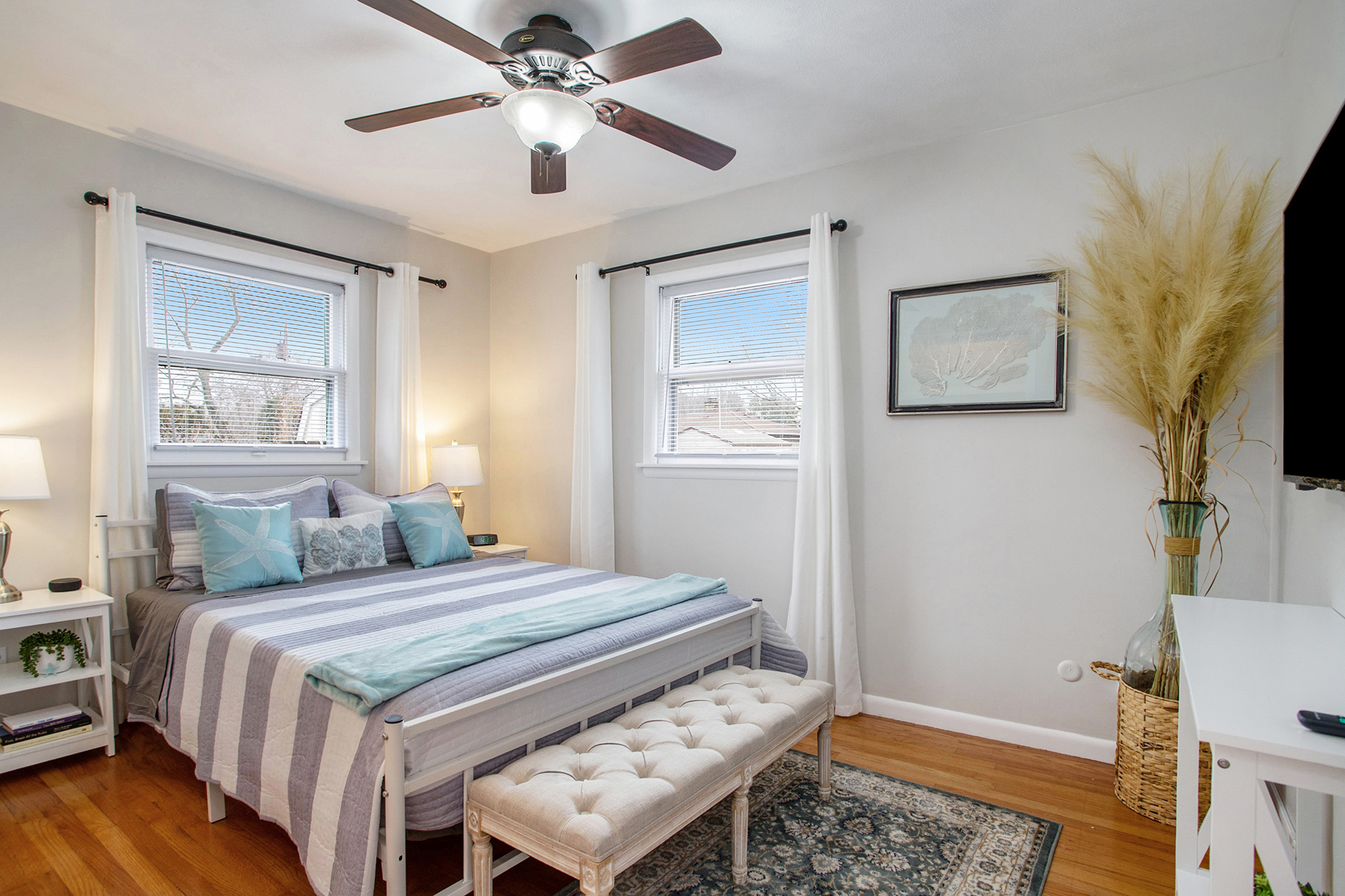 Bright cozy bedroom with striped bedding and decor