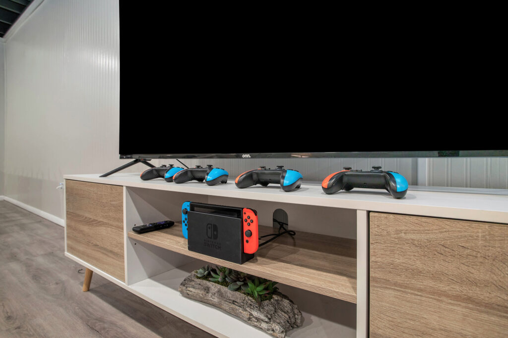 TV stand with gaming console and controllers