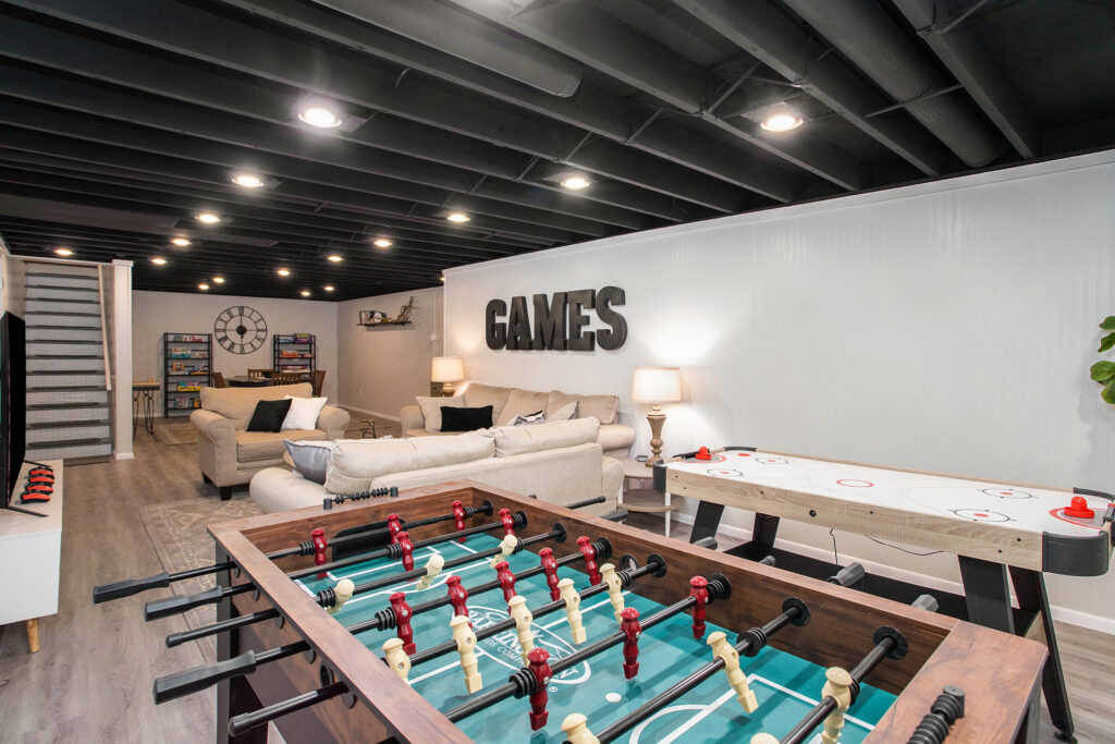 Modern basement game room with foosball and air hockey