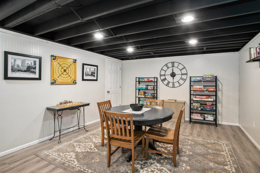 Cozy basement game room with table and board games