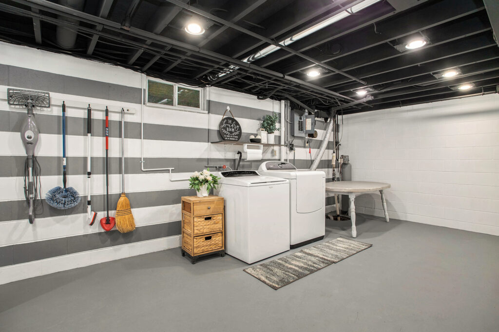 Modern basement laundry room with washer and dryer