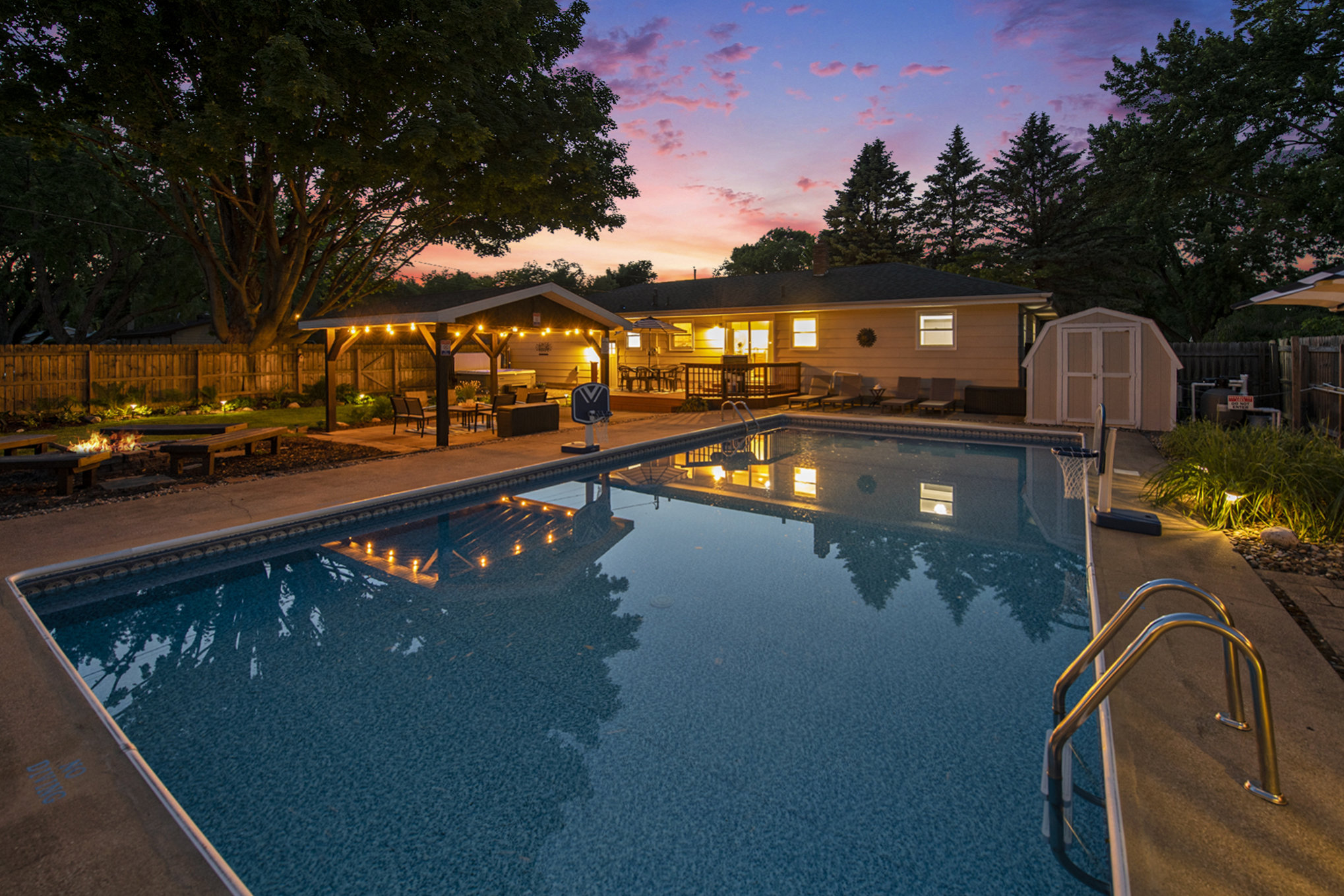 Backyard pool and patio at sunset