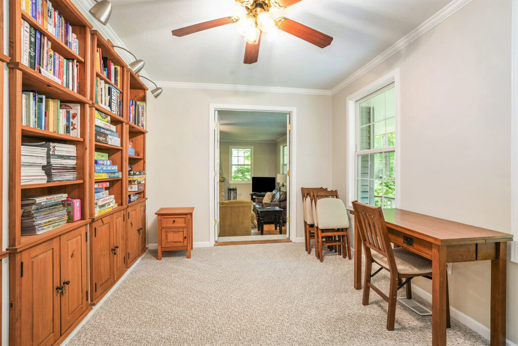 Home office with wooden desk and bookshelves