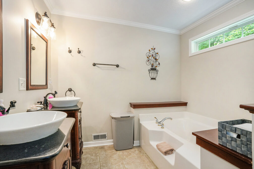 Modern bathroom with double sinks and bathtub