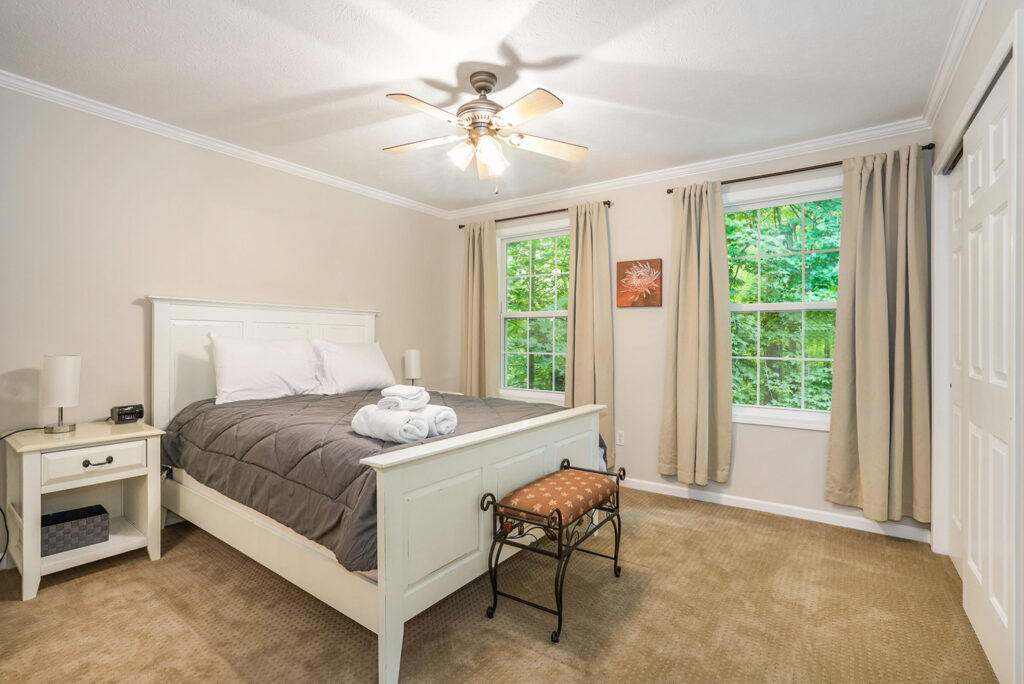 Cozy bedroom with large windows and neutral decor