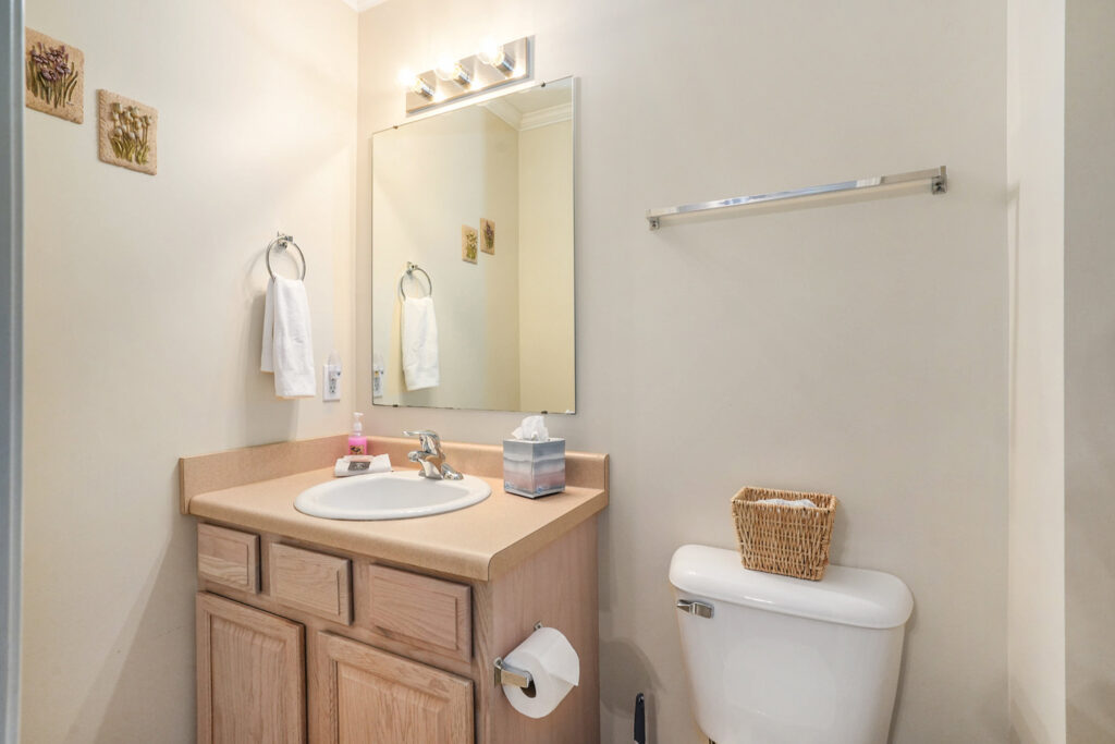 Small bathroom with sink, mirror, and toilet