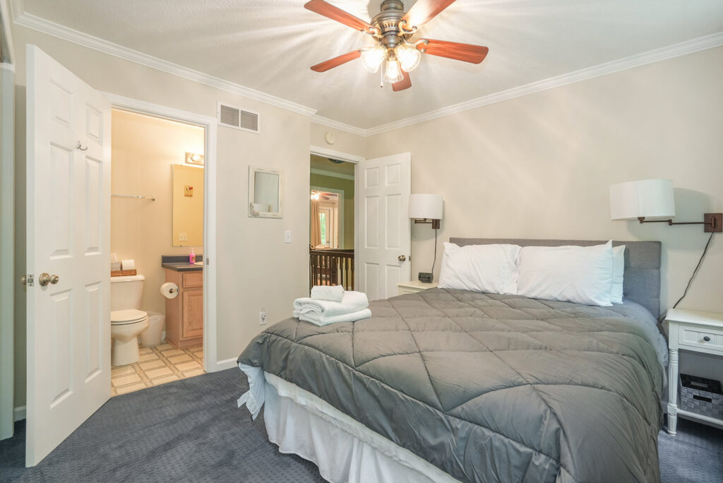 Cozy bedroom with bed and bathroom view