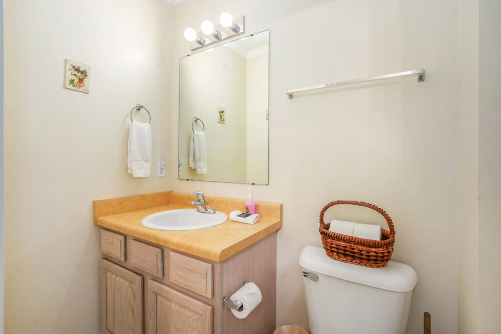 Small bathroom with sink, mirror, and toilet