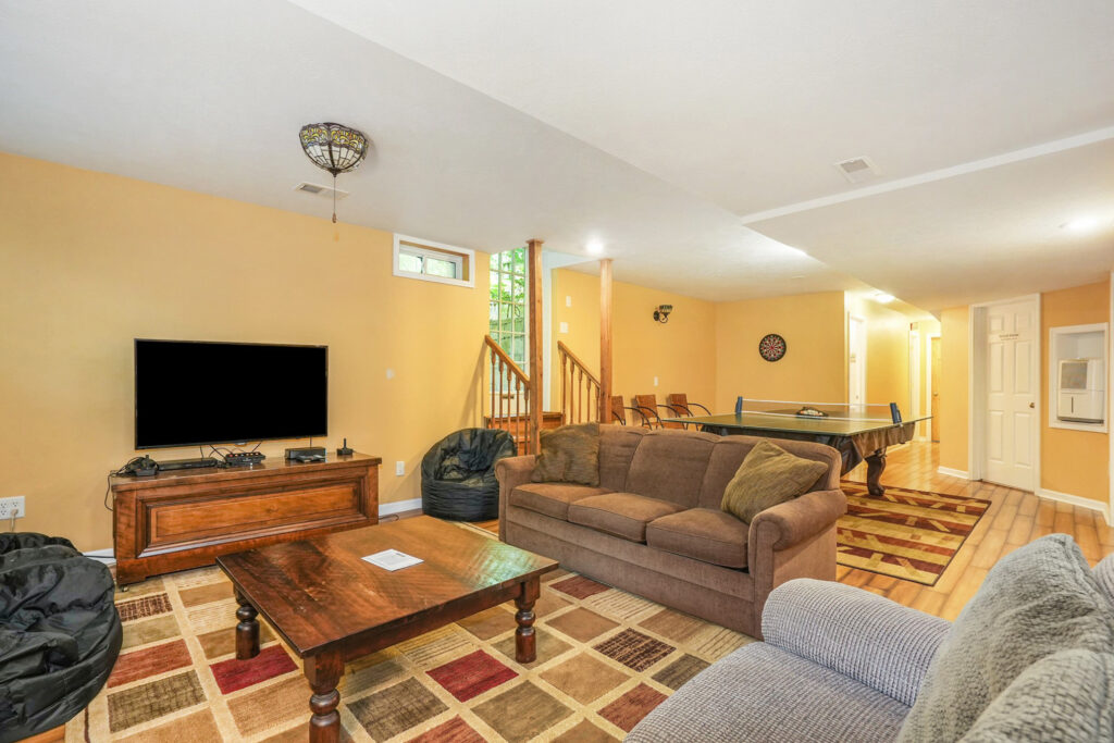 Spacious basement with TV and ping pong table